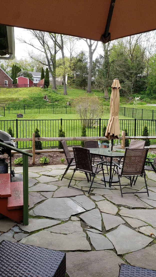 Here is a picture of the hill (upper left hand side of the picture with the house and barn-like shed on top). The view is from the bar on my patio.
