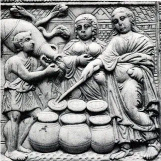 A carved relief of Christ touching stacked loaves with a wand, multiplying the bread