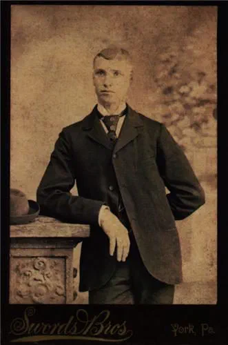 A sepia studio portrait of Nelson Rehmeyer as a young man