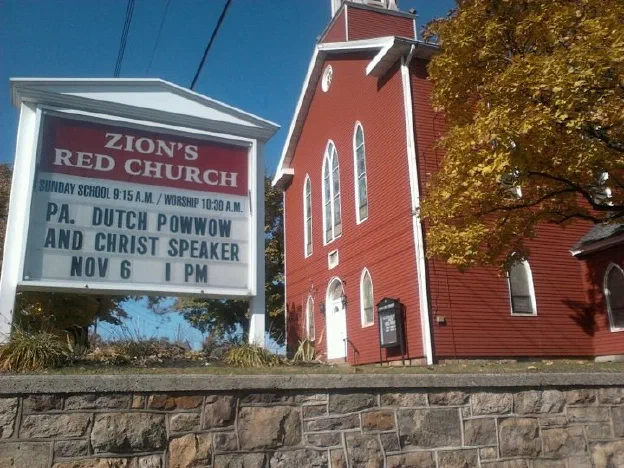 A Pennsylvania church with a marquee advertising a Pennsylvania Dutch Powwow talk
